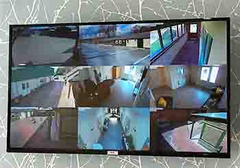 Large screen showing 9 sets of security camera footage in our cattery.